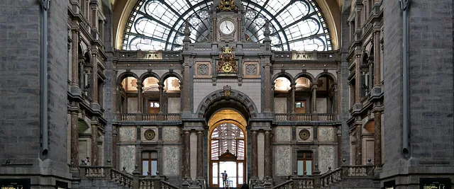 Travellers in the main hall of Antwerpen-Centraal railway station, under its arched glass window